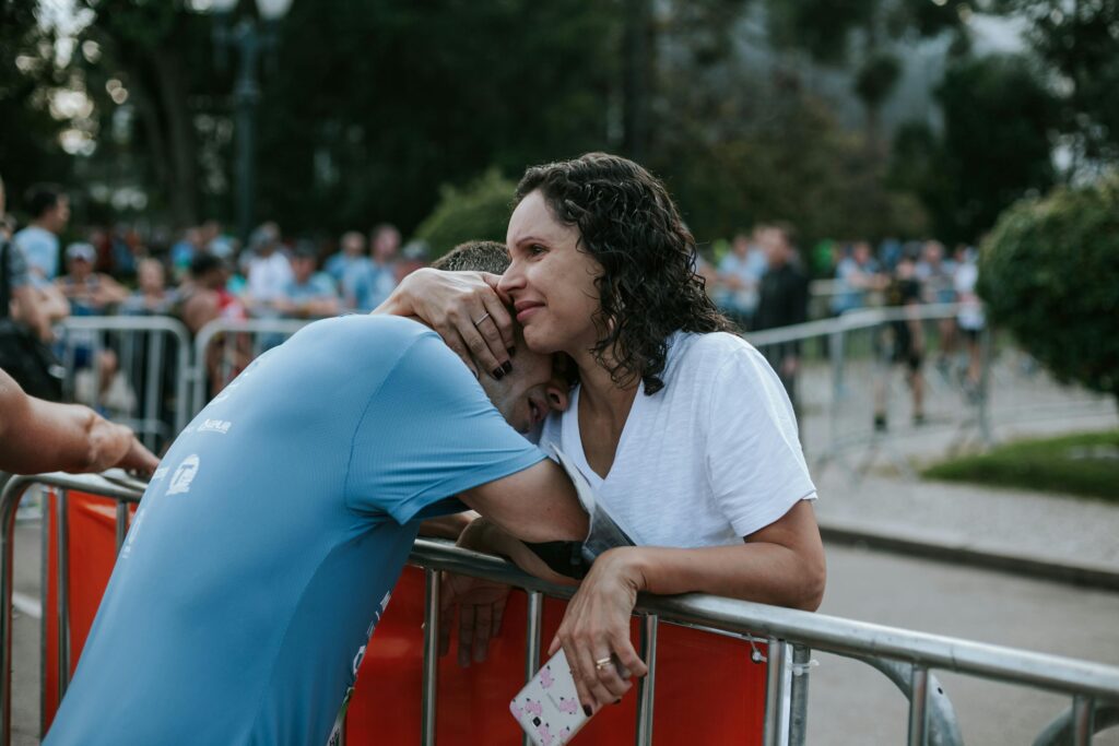 A couple comforting each other after a lost race. The image shows how to comfort someone with a Disorganized Attachment Style. 