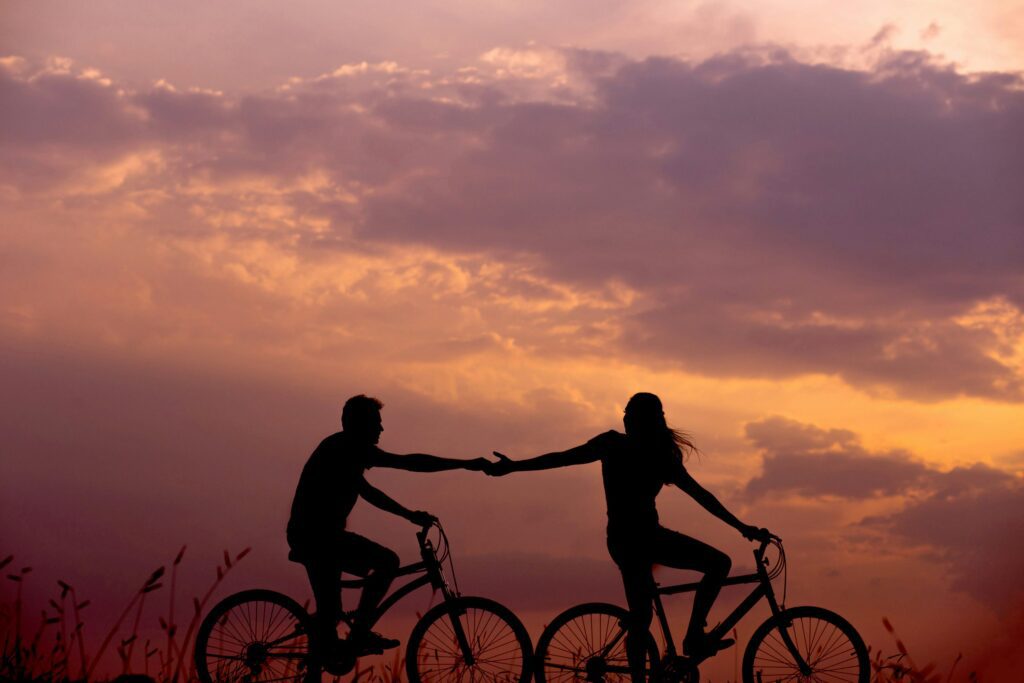 Couple riding bike. Leading a disorganized attachment style with compassion, not control. 